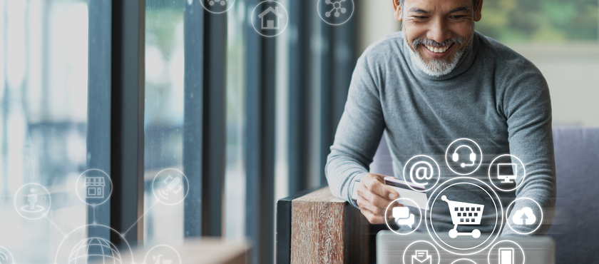 Asian or Hispanic man using Laptop and credit card payment shopping online with icon customer network connection on screen and connecting with omni channel system. Older man satisfied with CRM system